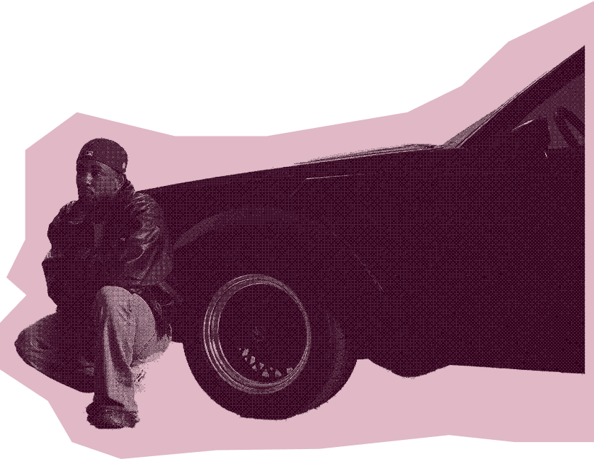 kendrick sits next to car